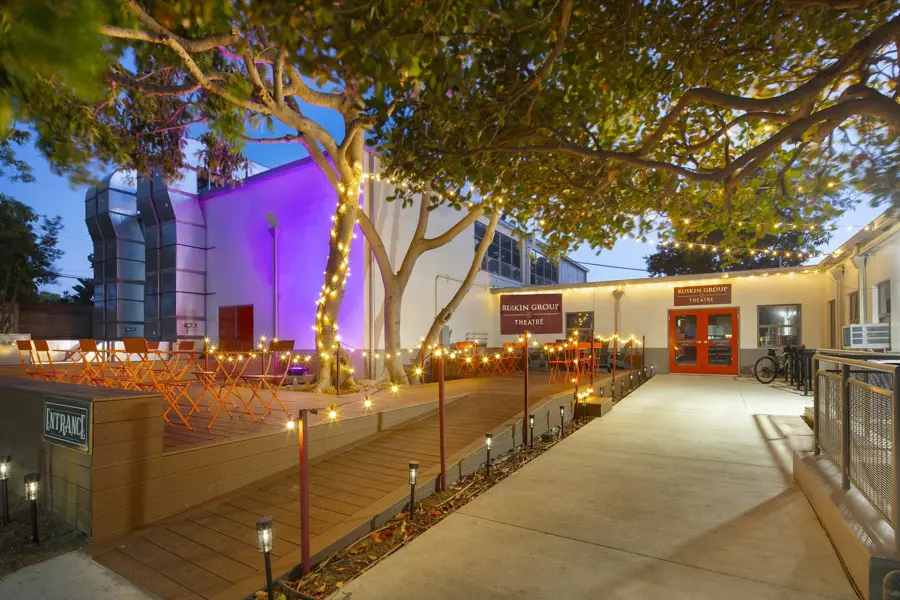 The finished Ruskin Group Theatre courtyard at dusk with string lights